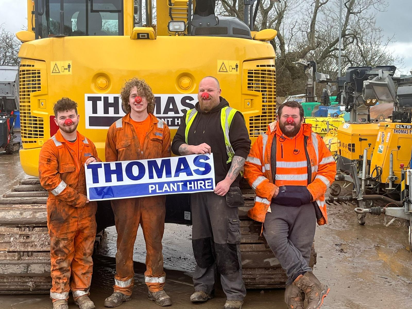 Thomas staff in front of digger with red noses on